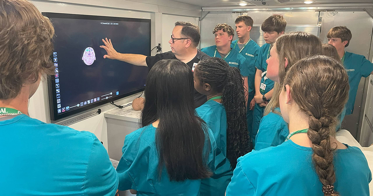 An instructor shows off a display board to MASH students